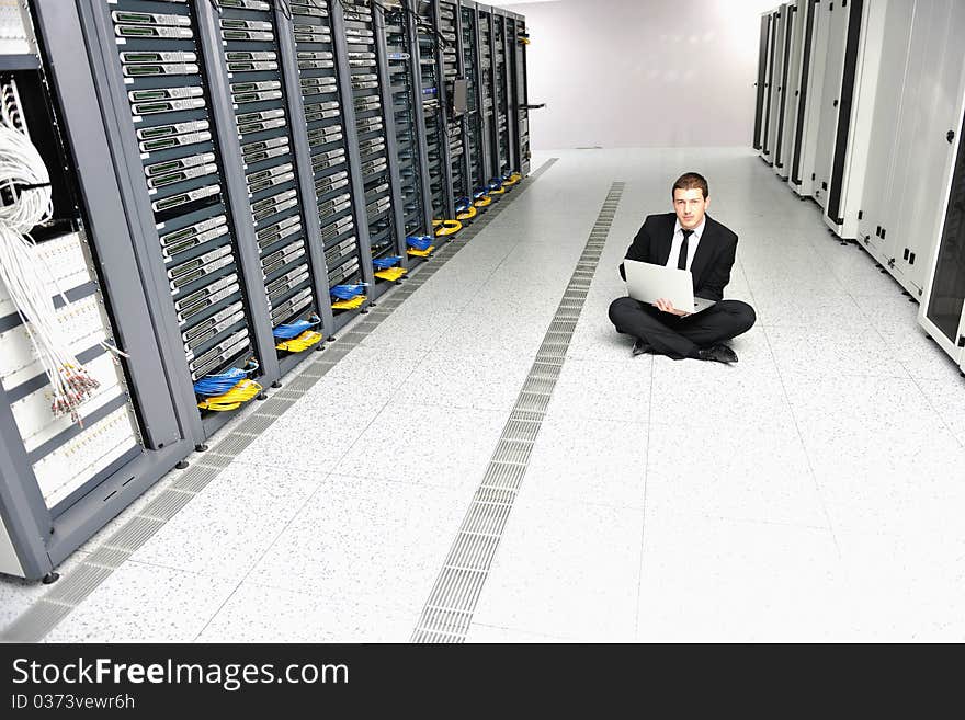 Young handsome business man it  engeneer in datacenter server room. Young handsome business man it  engeneer in datacenter server room