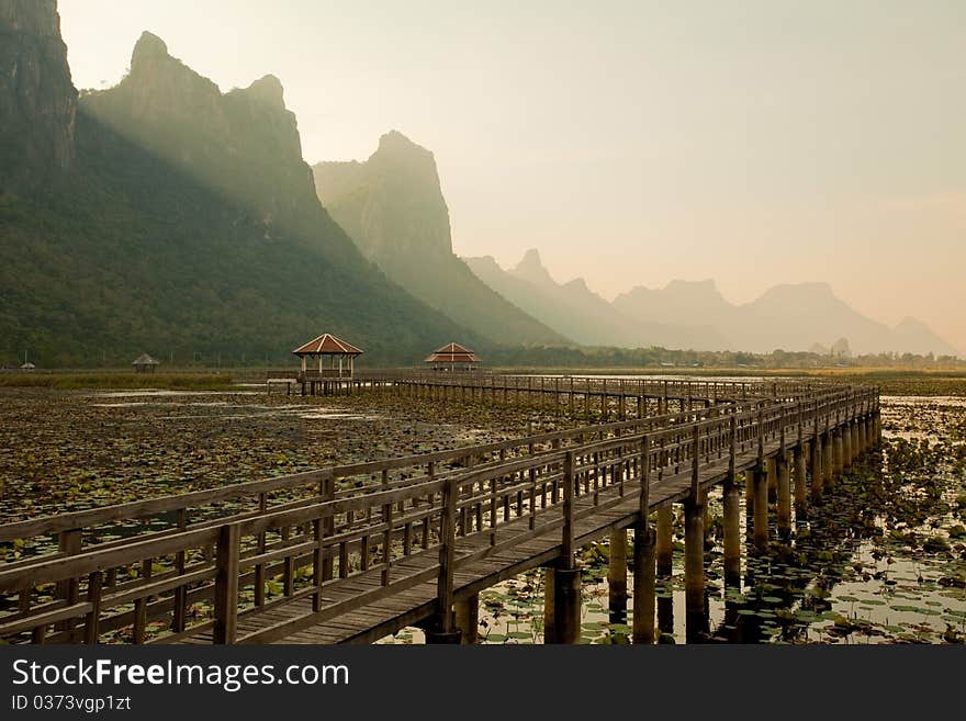 Footbridge in lake into the mountain, thailand