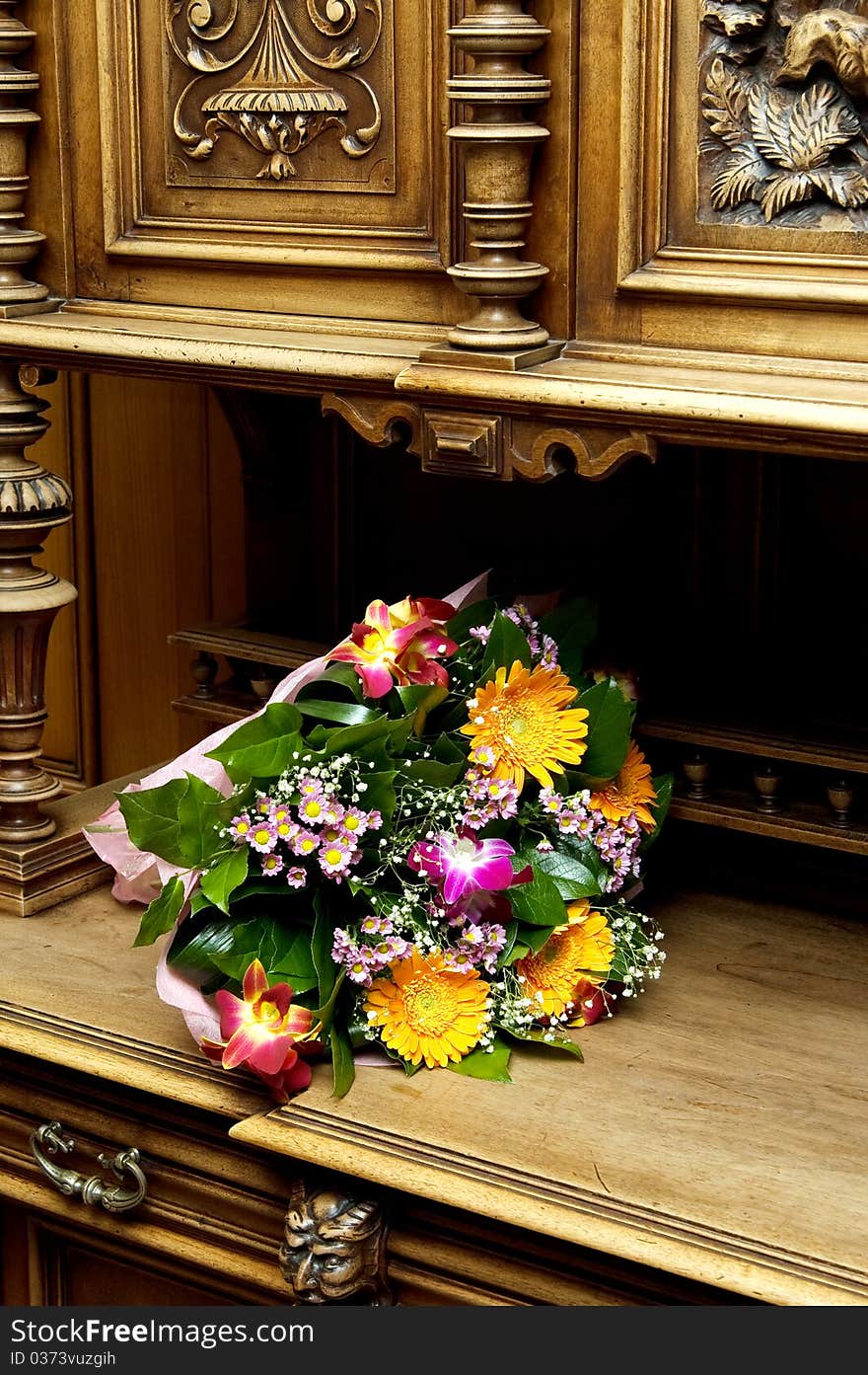 Bunch of wedding flowers on a old-style sideboard