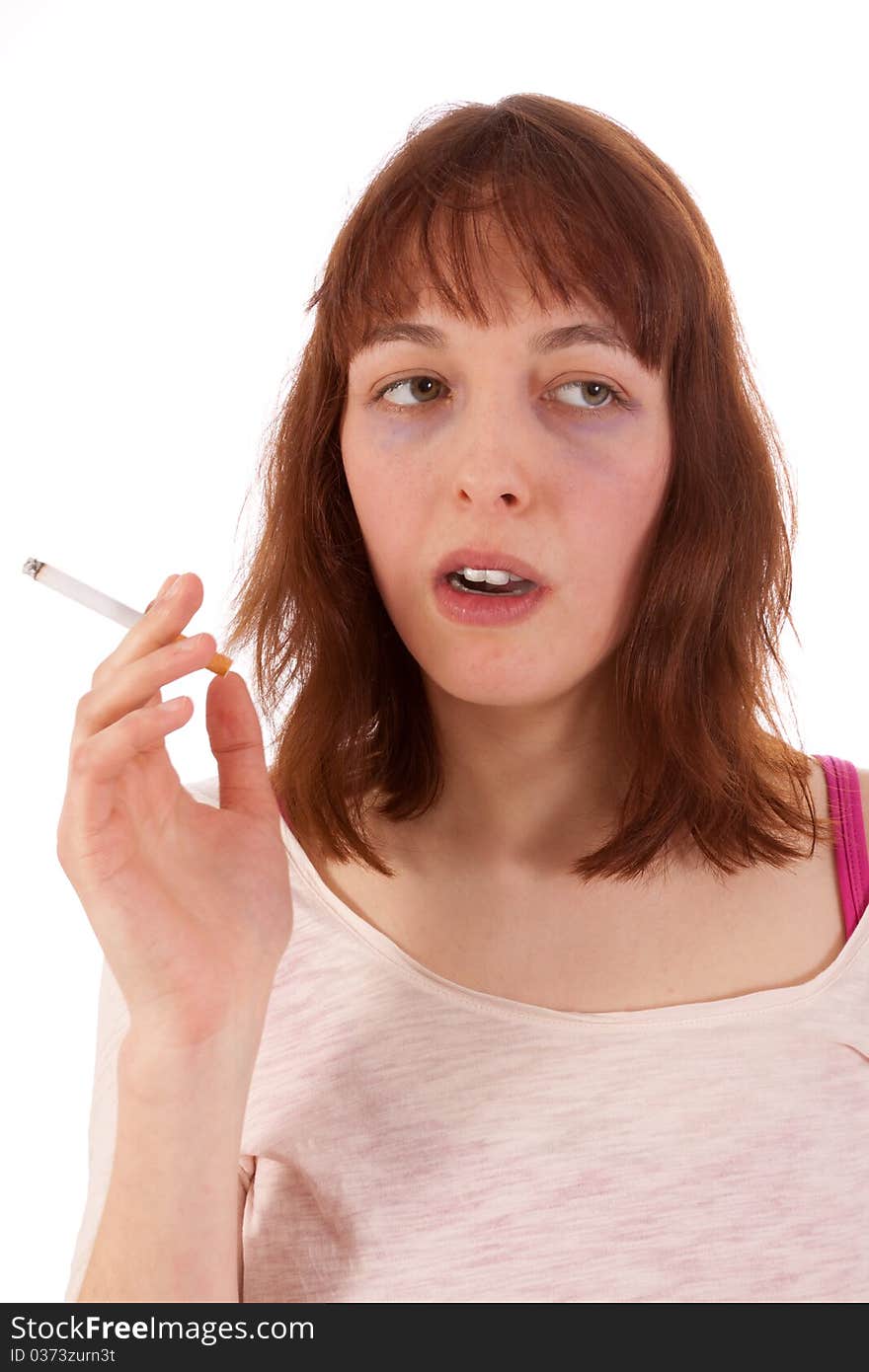 A young woman has a cigarette in her hand. A young woman has a cigarette in her hand