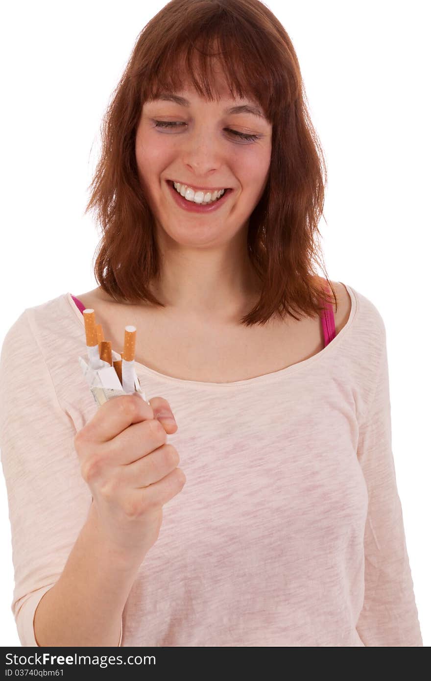 A young woman is happily screwing up a pack of cigarettes. A young woman is happily screwing up a pack of cigarettes