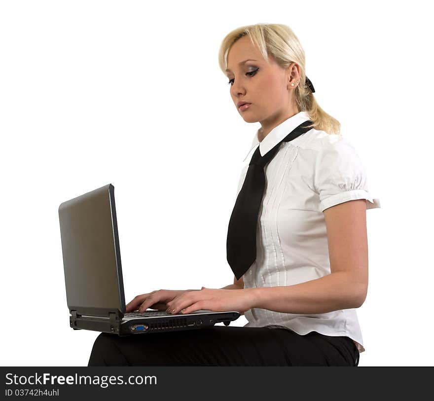 Blond girl working at a laptop isolated on white. Blond girl working at a laptop isolated on white.