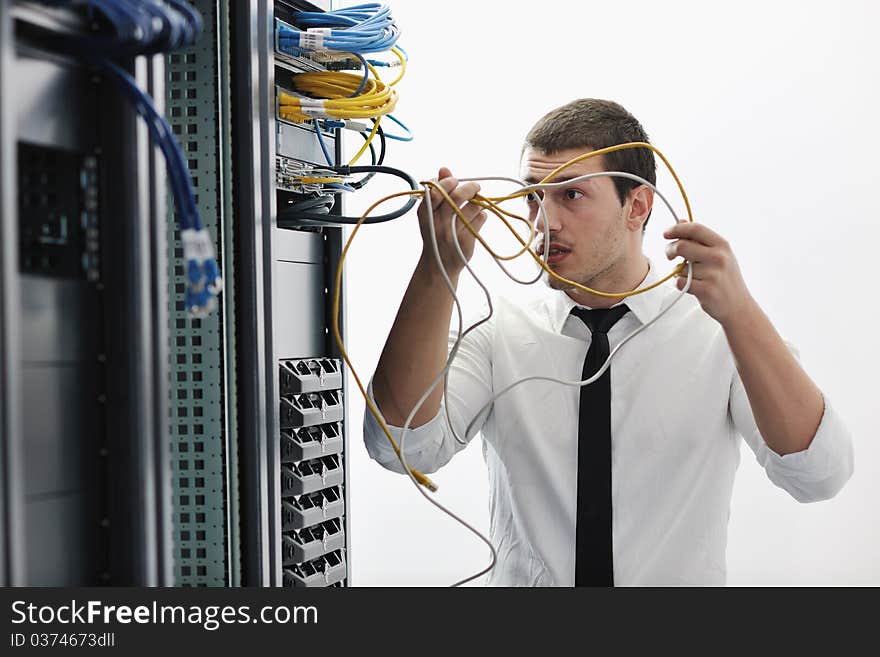 Young handsome business man it engeneer in datacenter server room. Young handsome business man it engeneer in datacenter server room