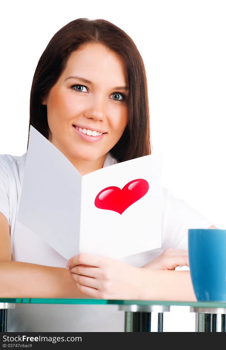 Beautiful girl is reading a valentine isolated on white