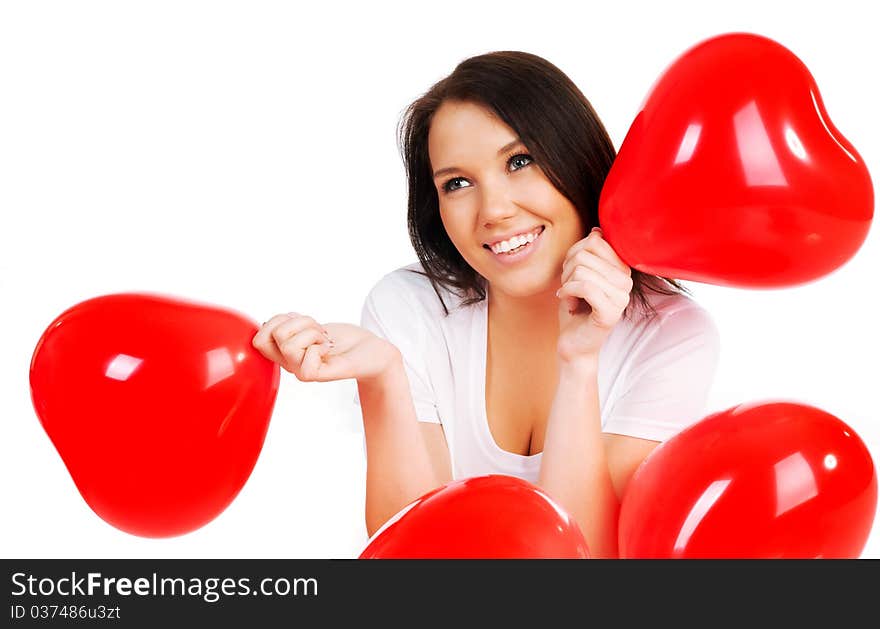 Beautiful young brunette with red hearts isolated on white background