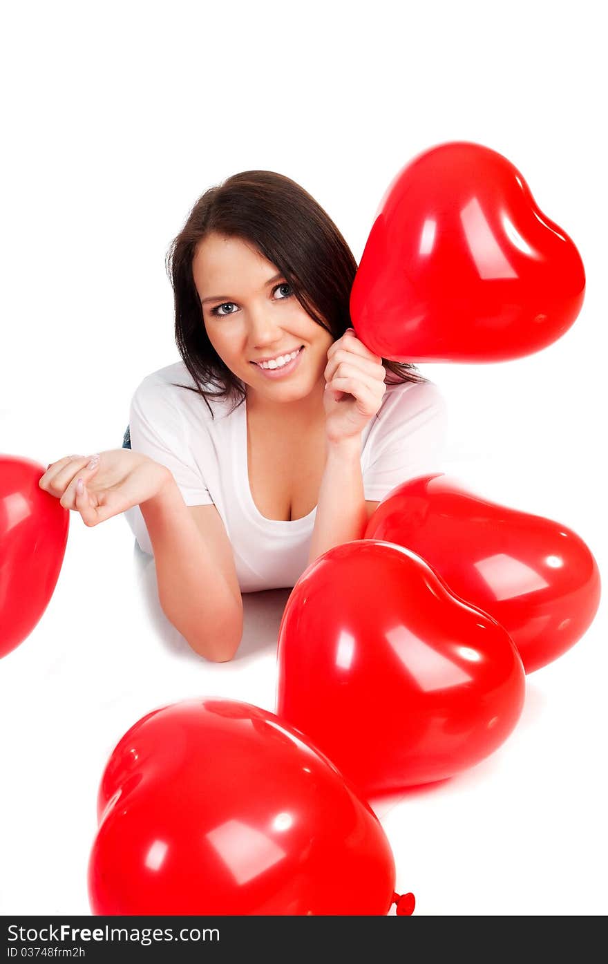 Beautiful young brunette with red hearts isolated on white background