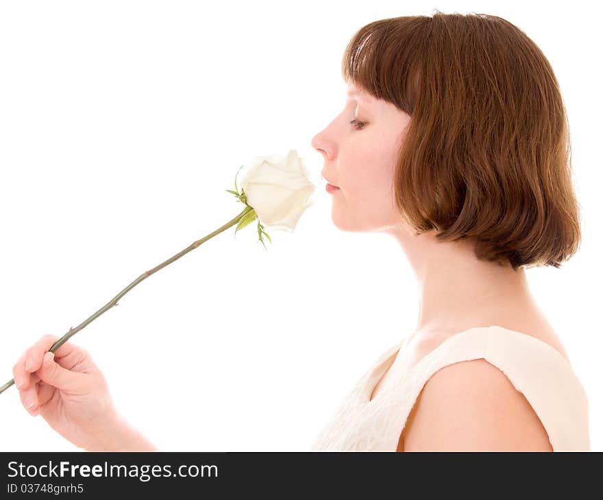 Girl sniffs a rose on a white background. Girl sniffs a rose on a white background.