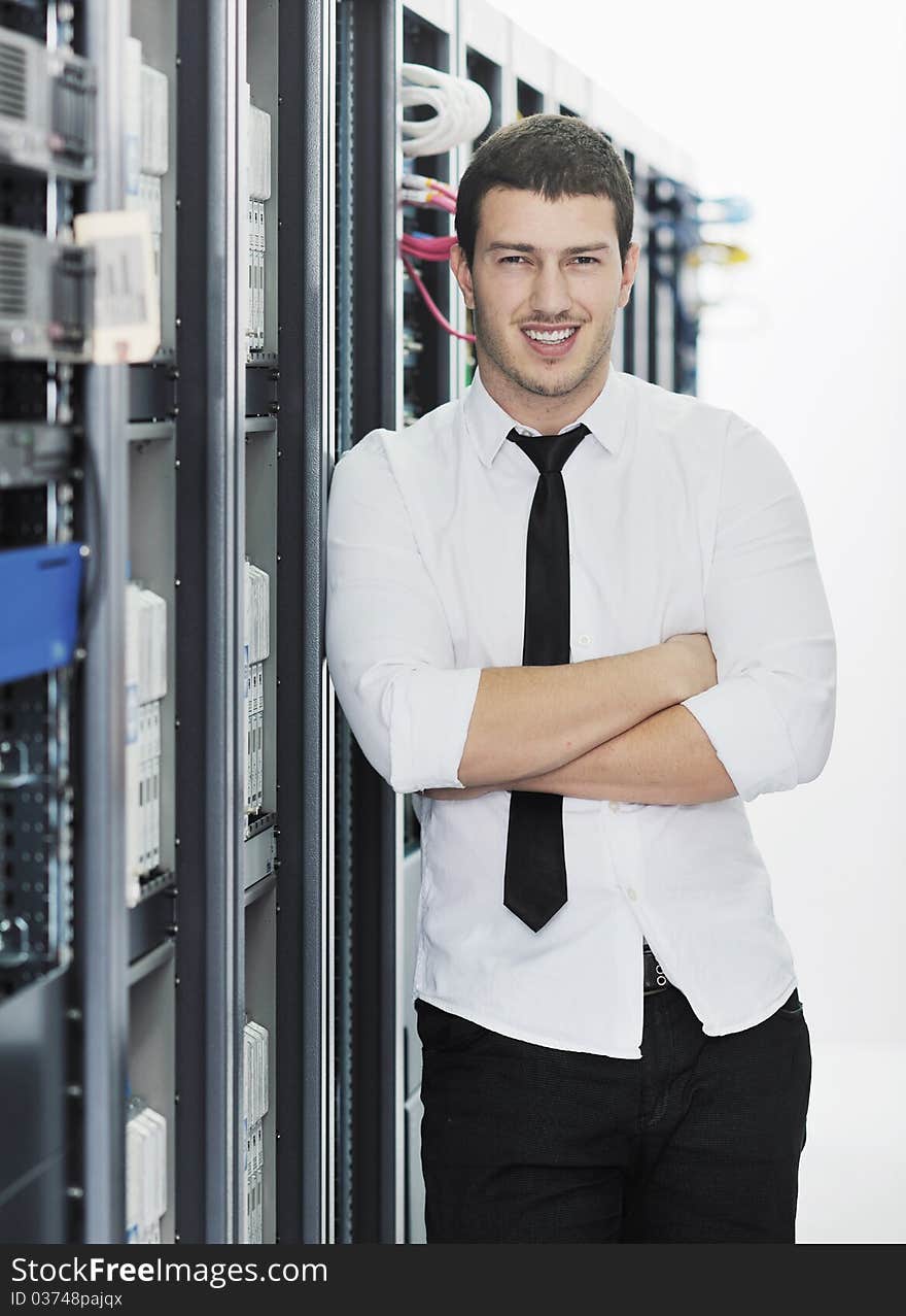 Young handsome business man it  engeneer in datacenter server room. Young handsome business man it  engeneer in datacenter server room