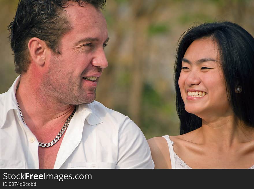 One couple talked happy in the park. One couple talked happy in the park