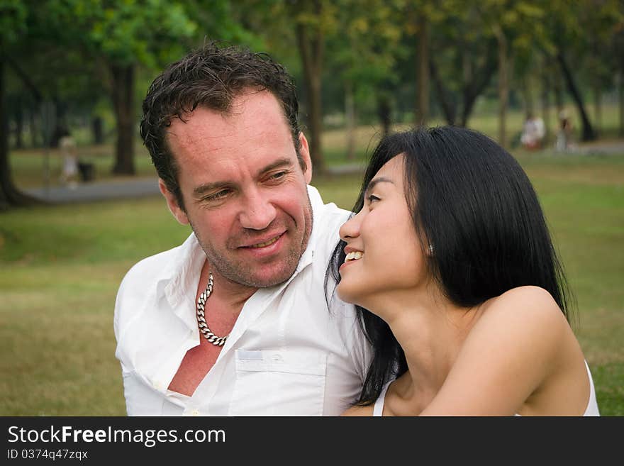 One couple talked happy in the park. One couple talked happy in the park