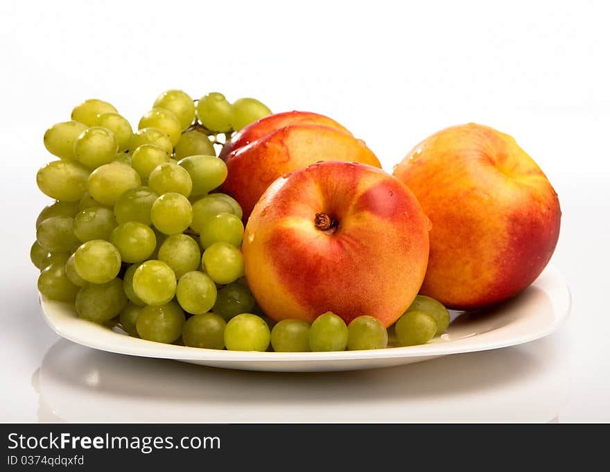 Grape and peaches on the white background. Grape and peaches on the white background