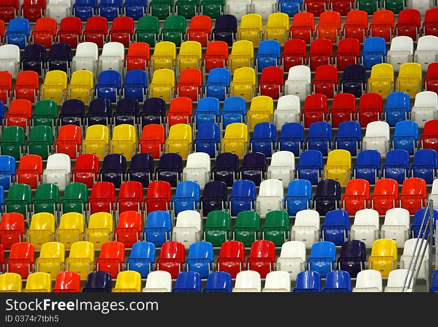 Perspective of rows multicolored seats on the sport tribune