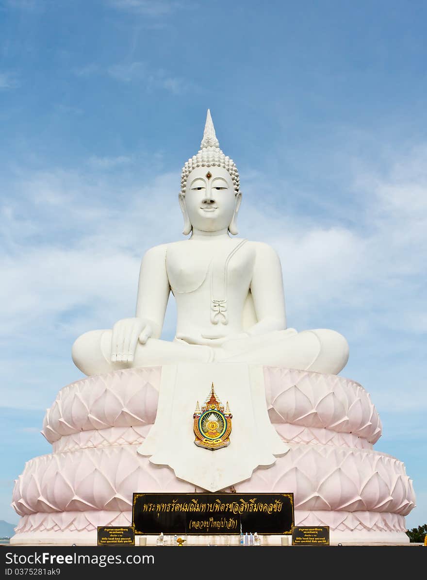 White Buddha statue with blue sky.