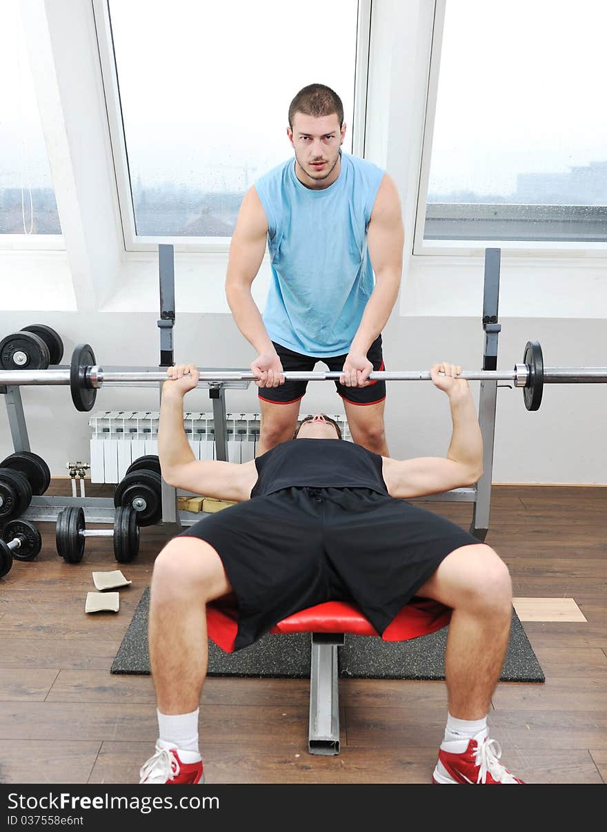 Young man in fintess sport club exercise withweights and relaxing. Young man in fintess sport club exercise withweights and relaxing