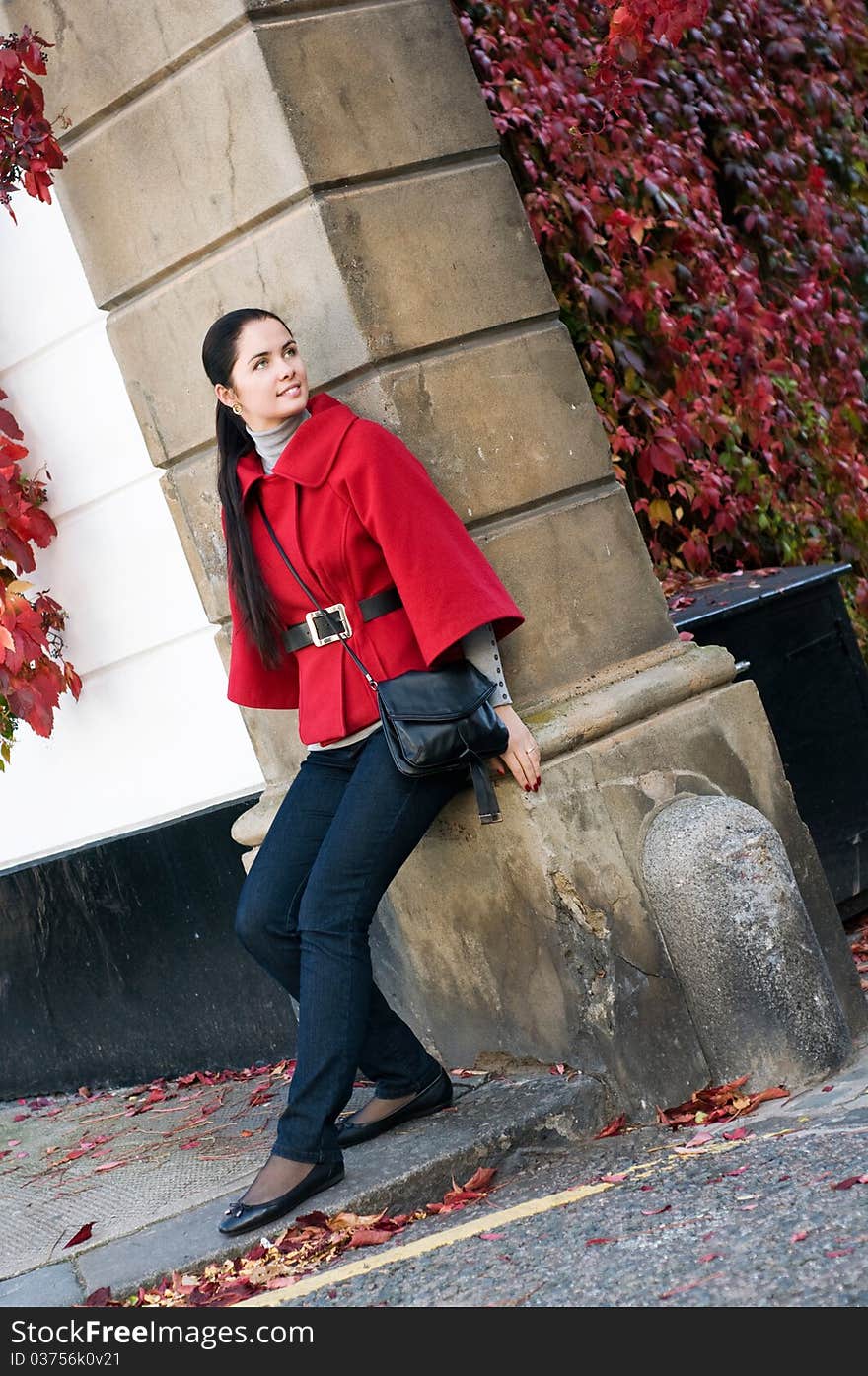 Young women in red coat on the street