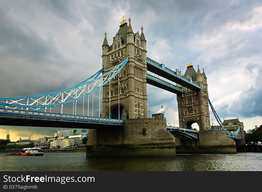 Tower Bridge against a dramatic cloudy sky background, London, UK