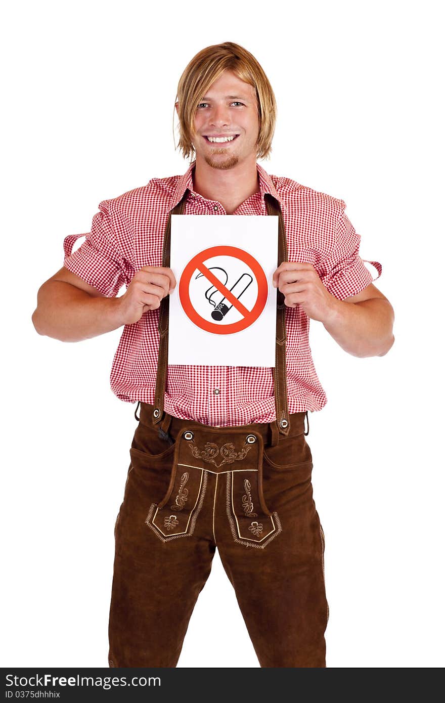 Smiling Bavarian man in lederhose holds non-smoking-rule sign. Isolated on white background. Smiling Bavarian man in lederhose holds non-smoking-rule sign. Isolated on white background.