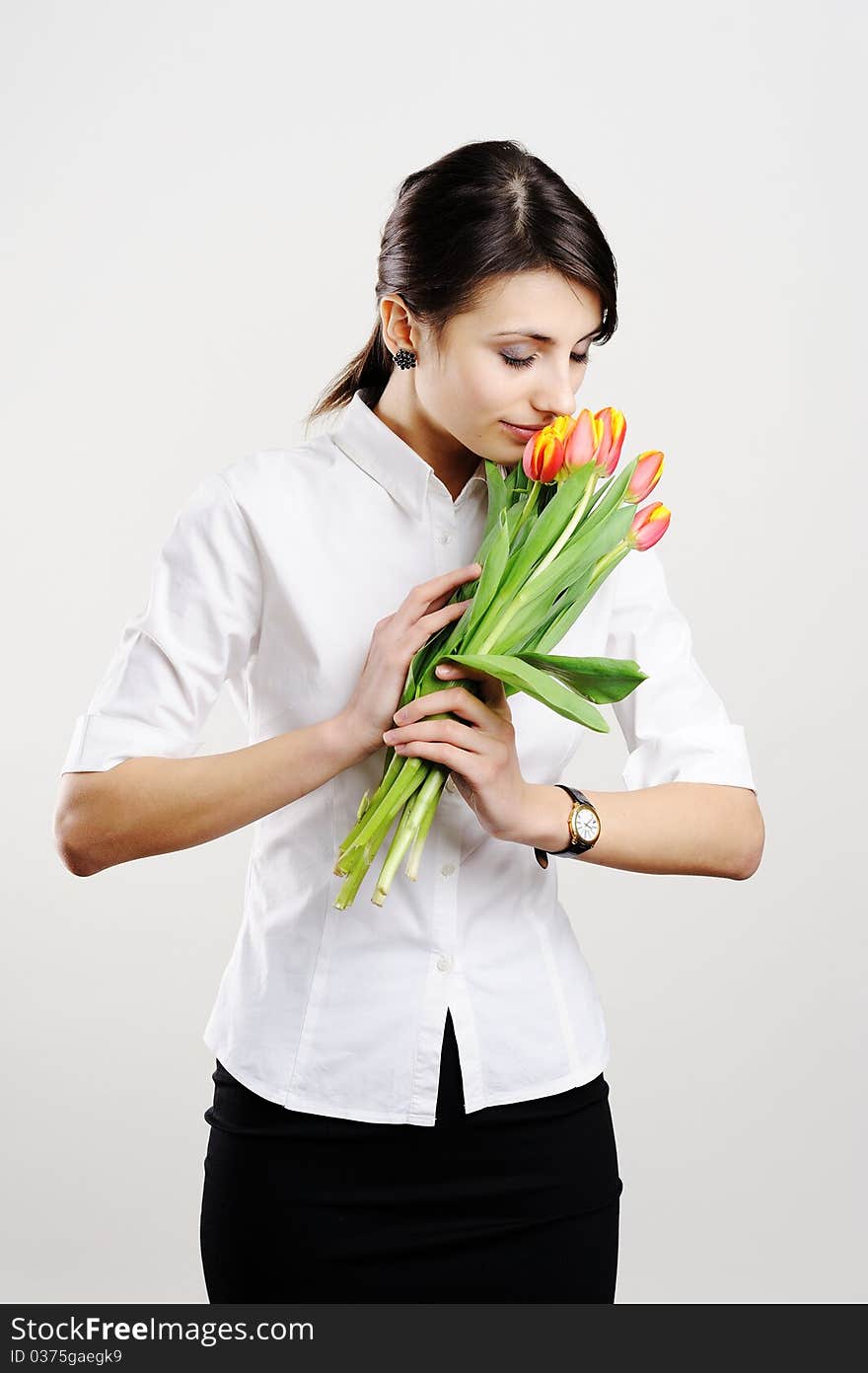 An image of young businesswoman with tulips