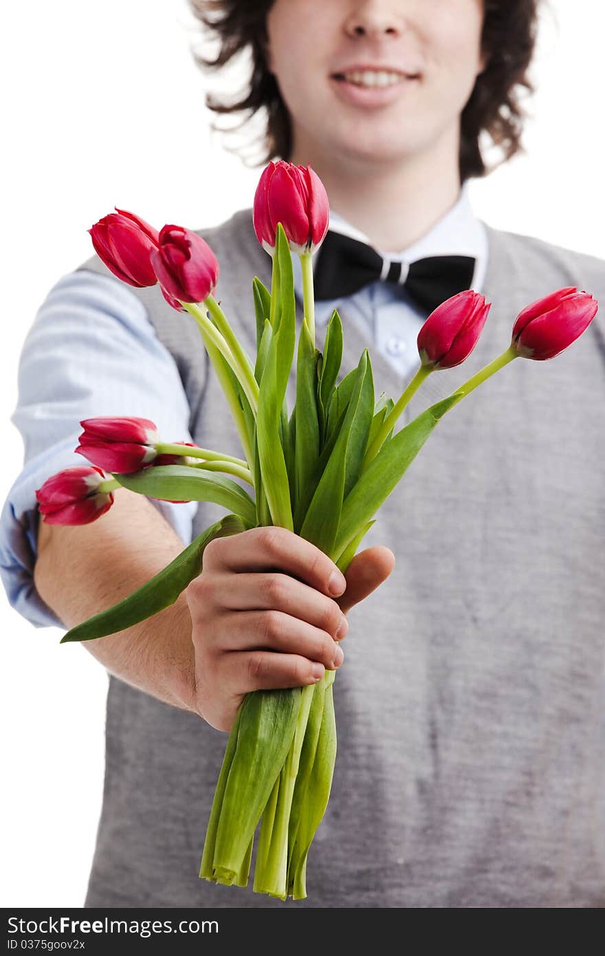 A young boy with a bouquet of red tulips. A young boy with a bouquet of red tulips