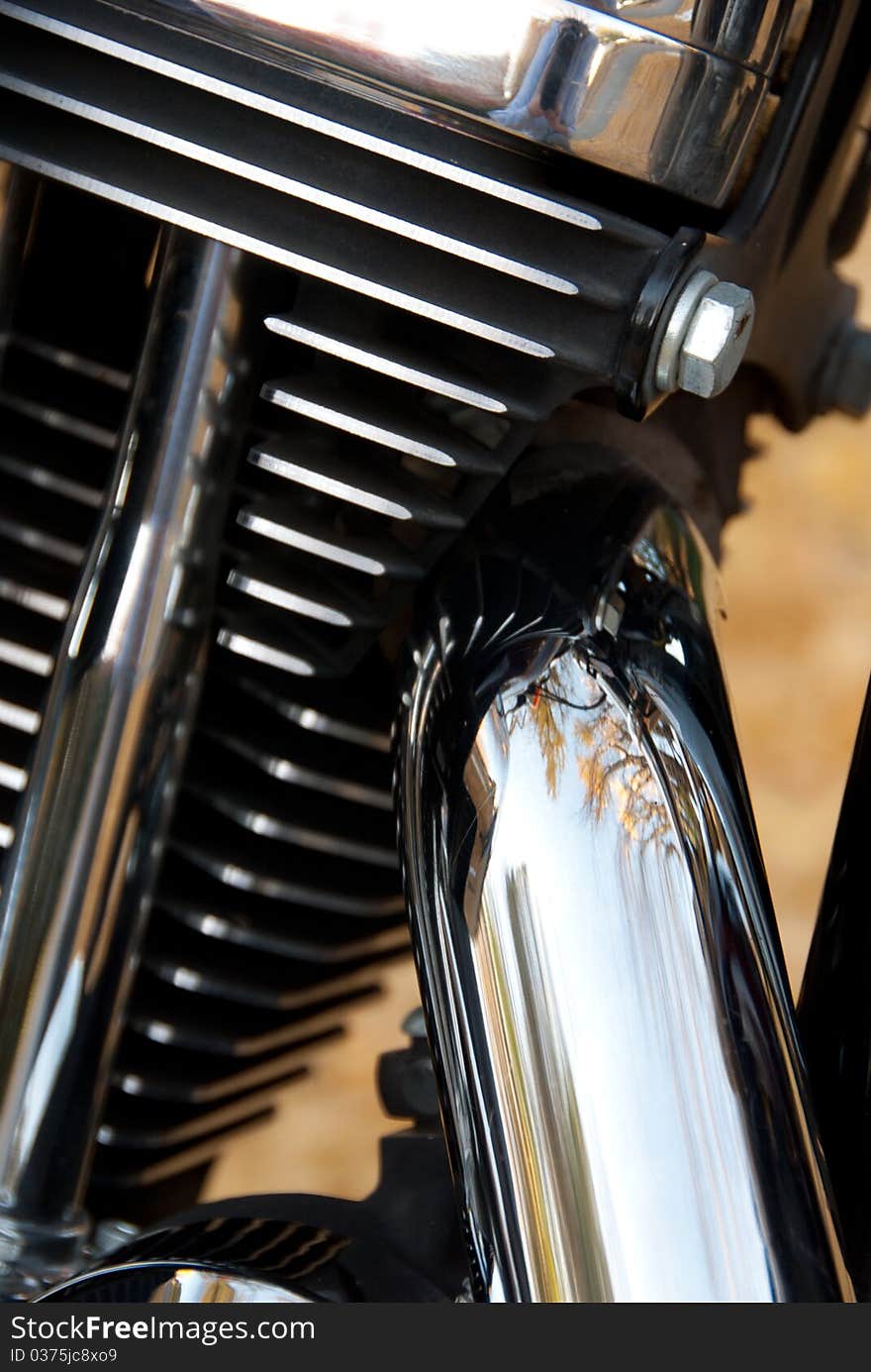 A close up of reflective motorcycle parts in a vertical orientation. A close up of reflective motorcycle parts in a vertical orientation