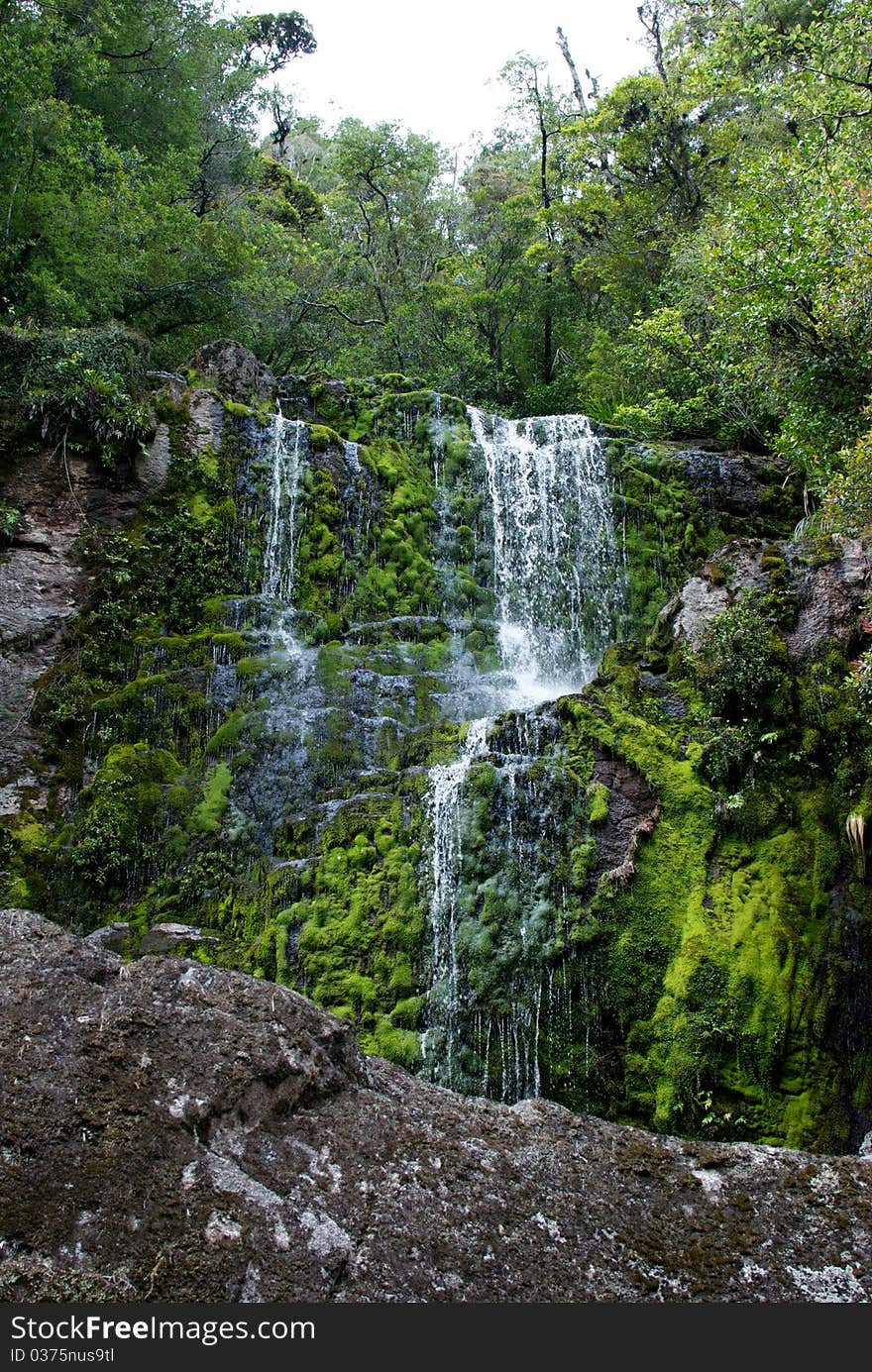 Walking in the beautiful West Coast of New Zealand. With a reputation of being wet you get these little waterfalls everywhere. Walking in the beautiful West Coast of New Zealand. With a reputation of being wet you get these little waterfalls everywhere