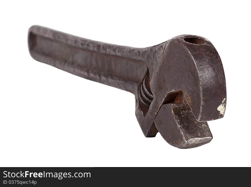 Old, metal adjustable wrench on white background