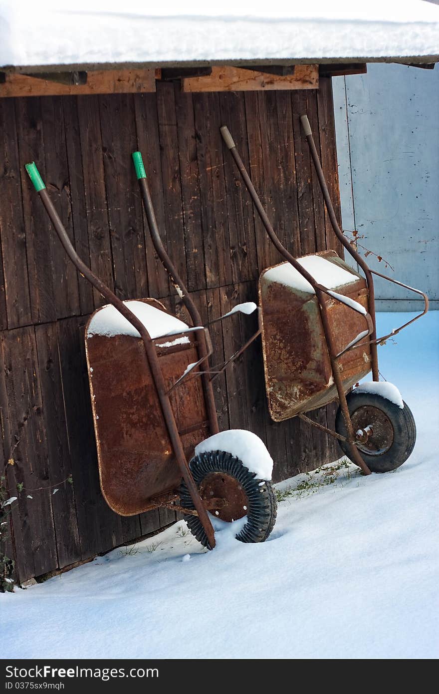 Retro wood shed with two wheelbarrow