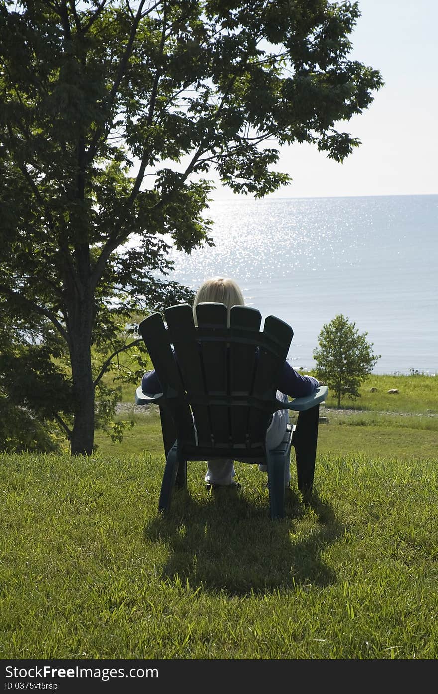 Woman relaxing at Lake Huron Michigan. Woman relaxing at Lake Huron Michigan