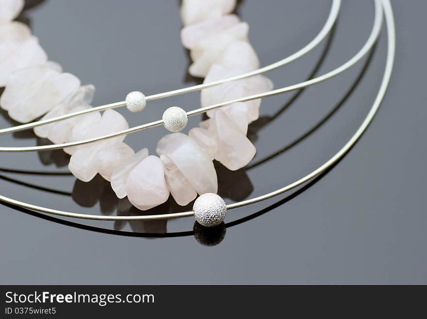 Arrangement of four pieces of necklaces on black background