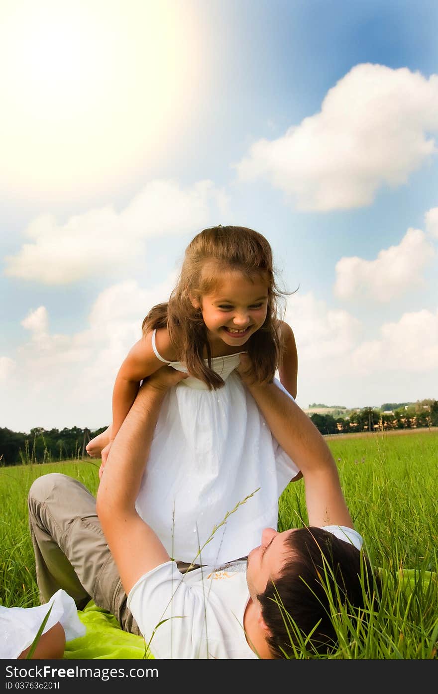 Father and daughter playing in the meadow