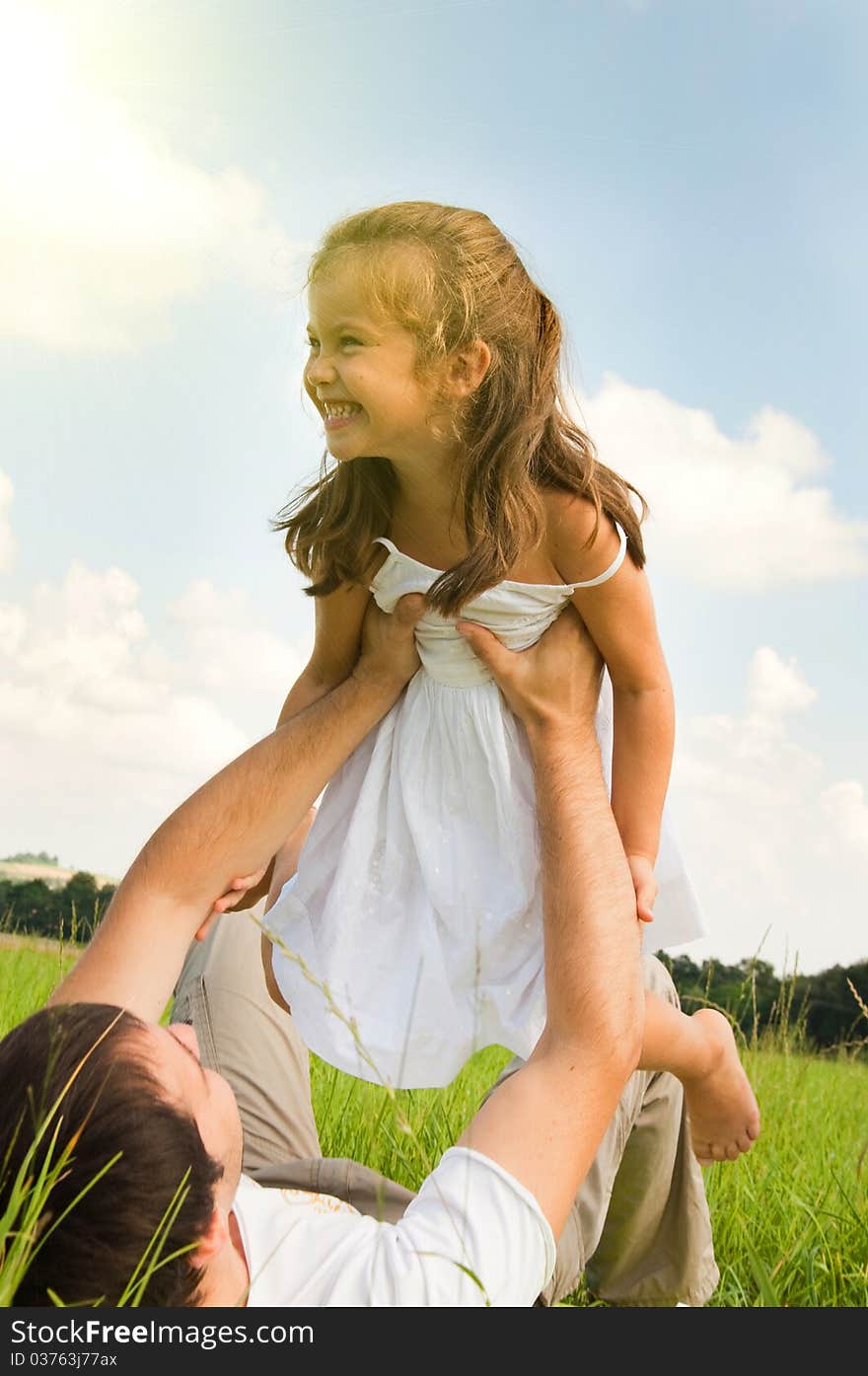 Father and daughter playing in the meadow