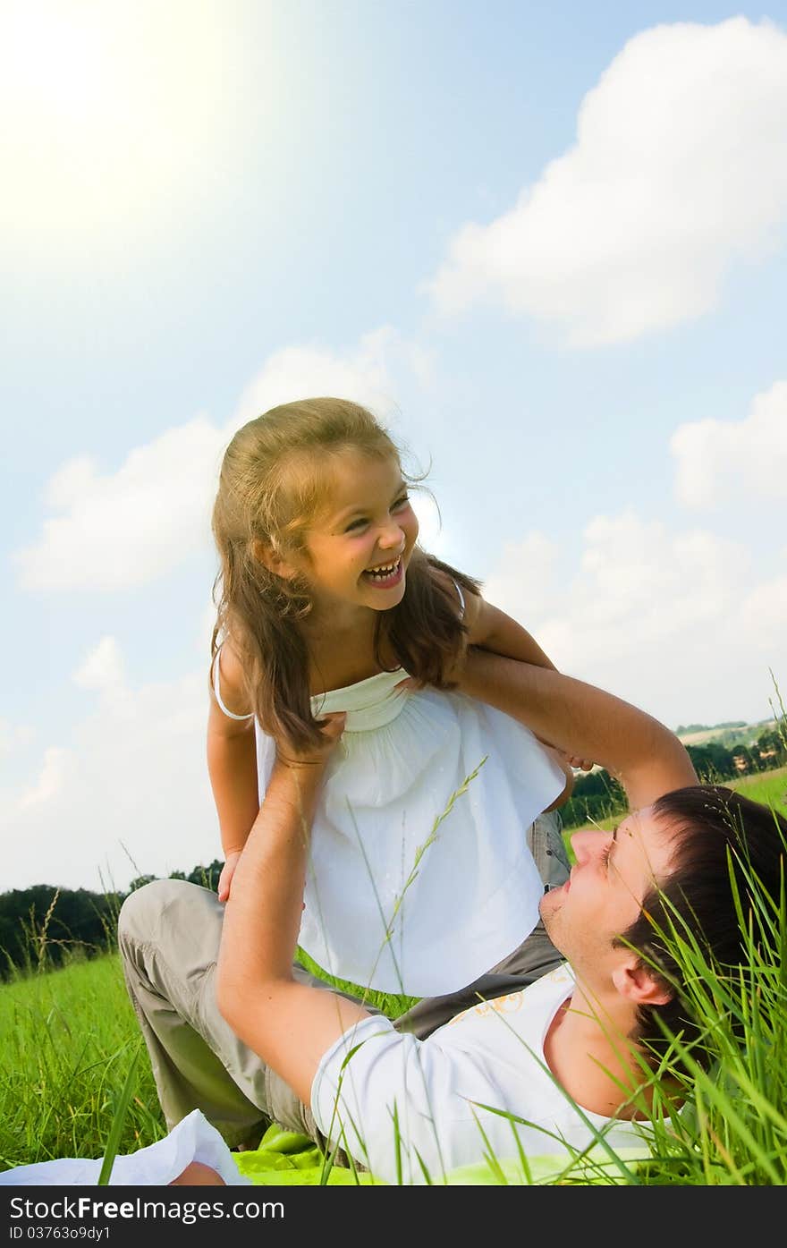 Father and daughter playing in the meadow