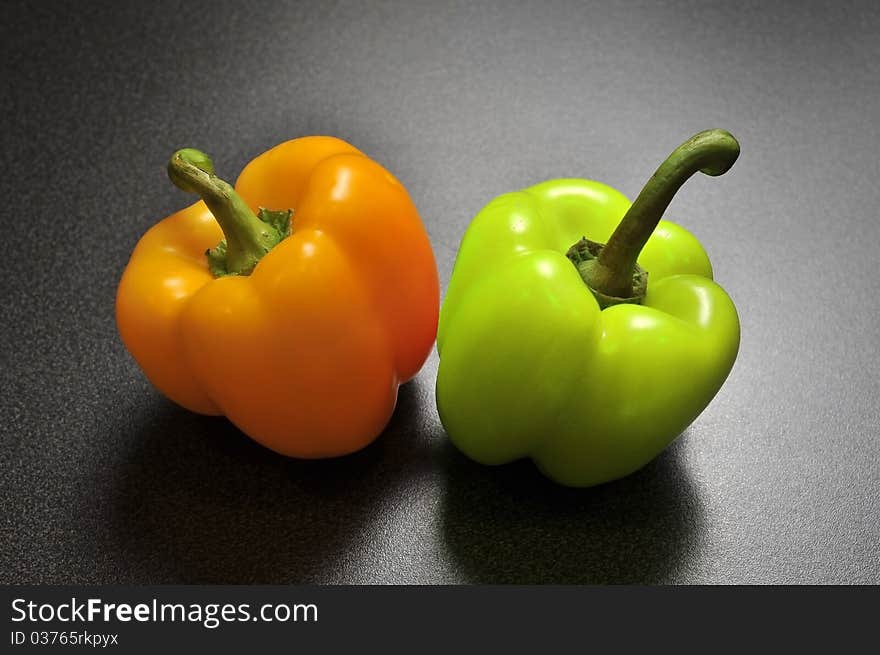 Two peppers on a kitchen table