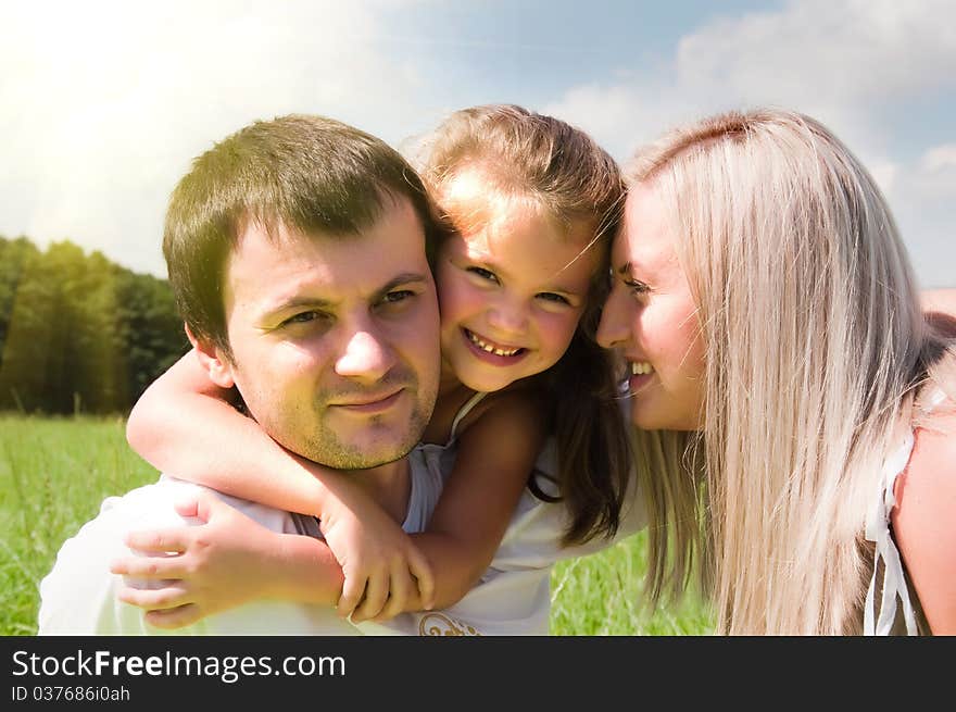 Young playful family on the meadow. Young playful family on the meadow