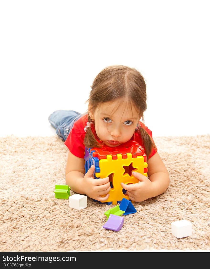 Little beauty girl on a floor with plastic toy. Little beauty girl on a floor with plastic toy