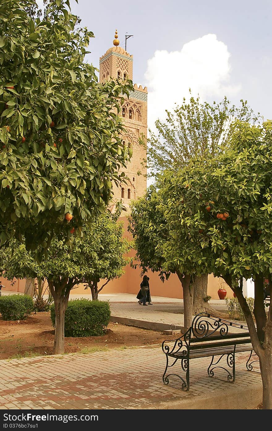 View of Koutoubia mosque tower in Marrakesh from a park with orange trees; Morocco. View of Koutoubia mosque tower in Marrakesh from a park with orange trees; Morocco