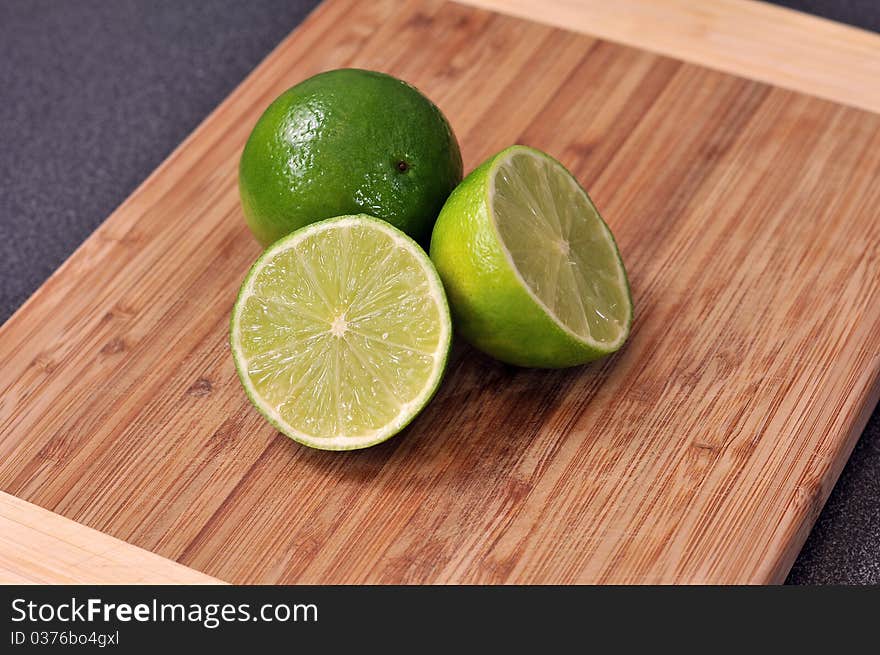 Sliced lime on a wooden plate