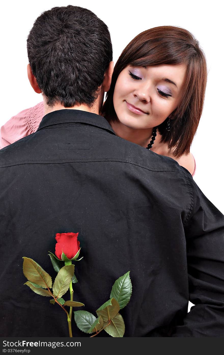 Happy beautiful teenage couple, a boy giving a rose to his girlfriend