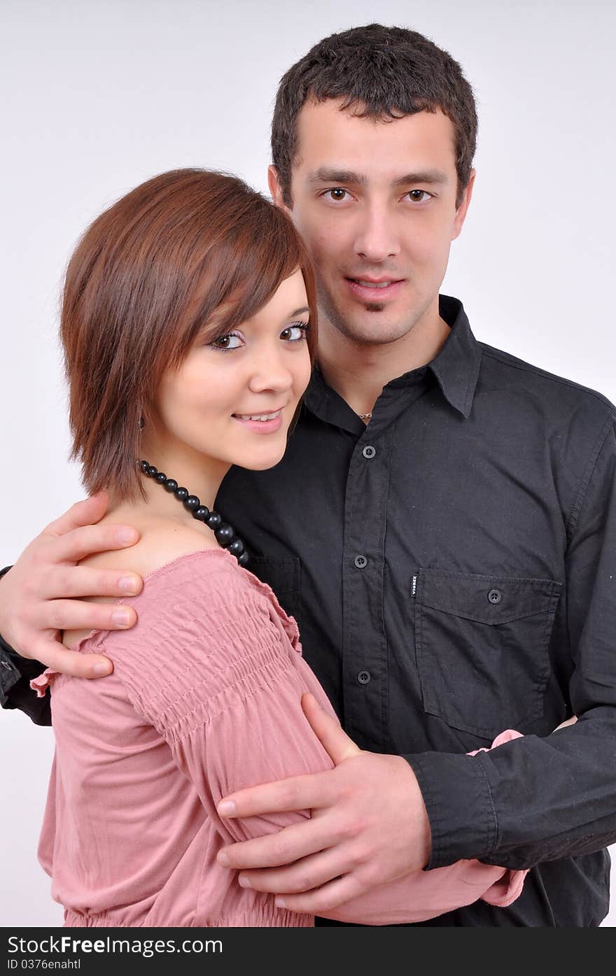 Woman and man posing on a grey background