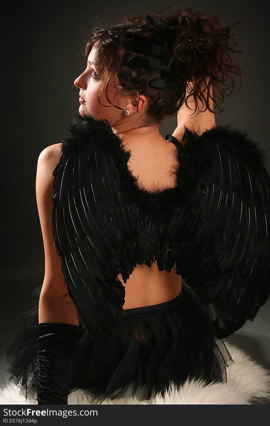 Beautiful young angel with black wings. Beautiful young angel with black wings