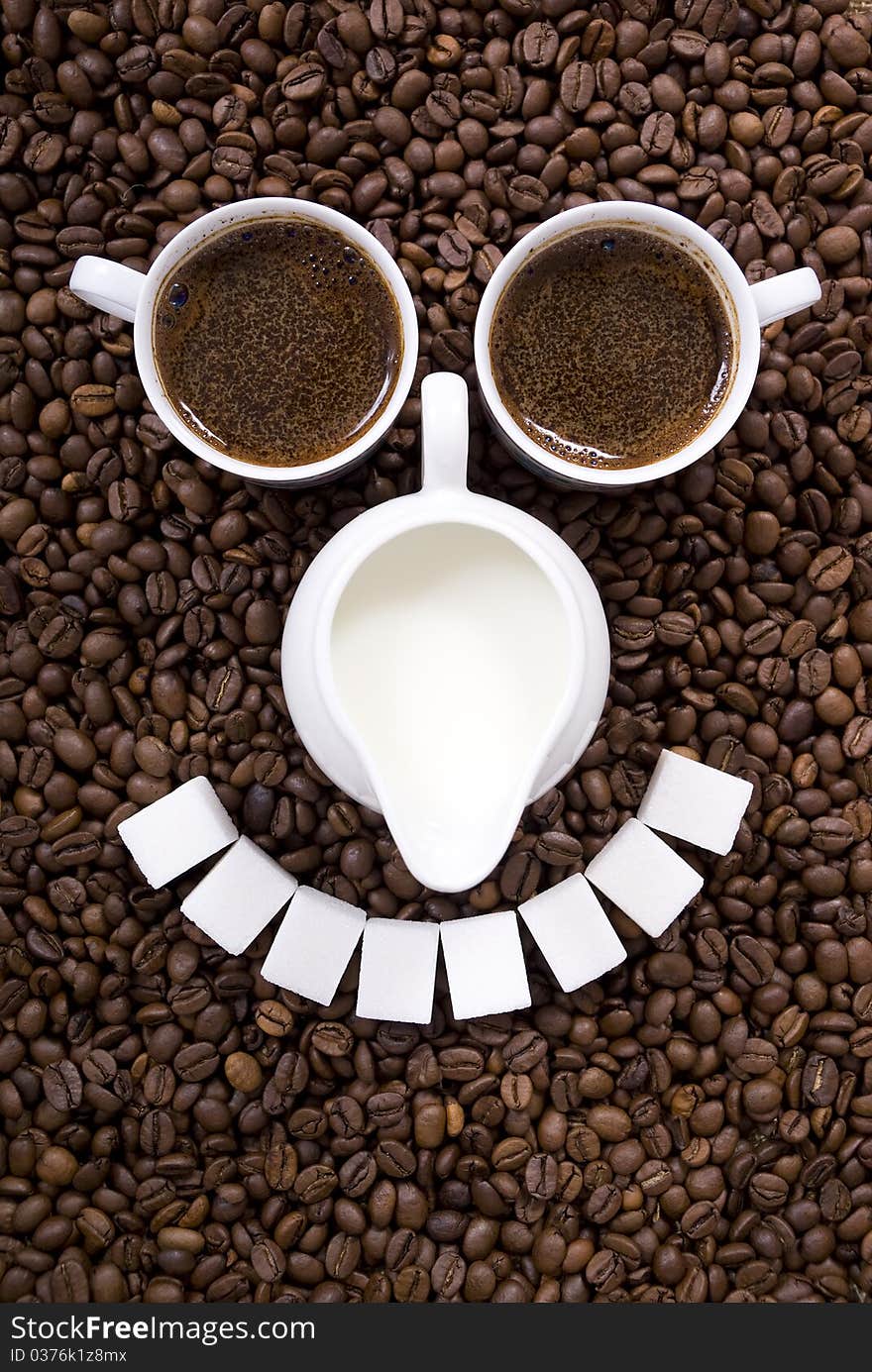 Cups with coffee on spilled grains of coffee