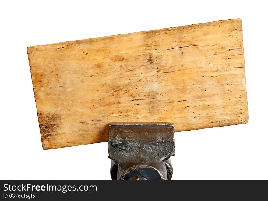 Dirty wood board in metal vice isolated. Industrial background. Dirty wood board in metal vice isolated. Industrial background