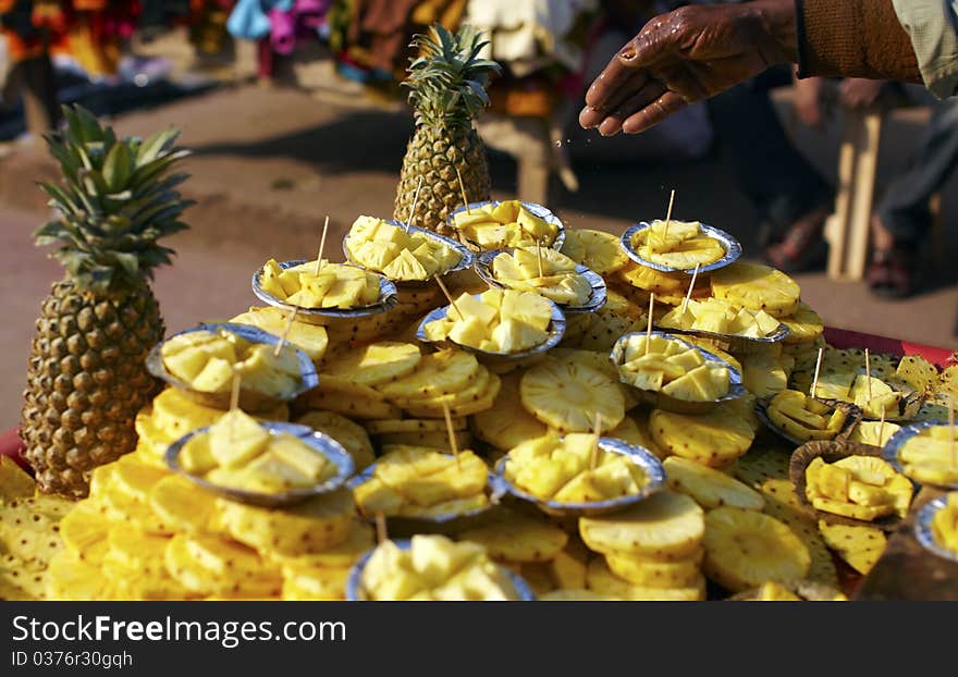 Cut pineapple fruit on the food stall in the market