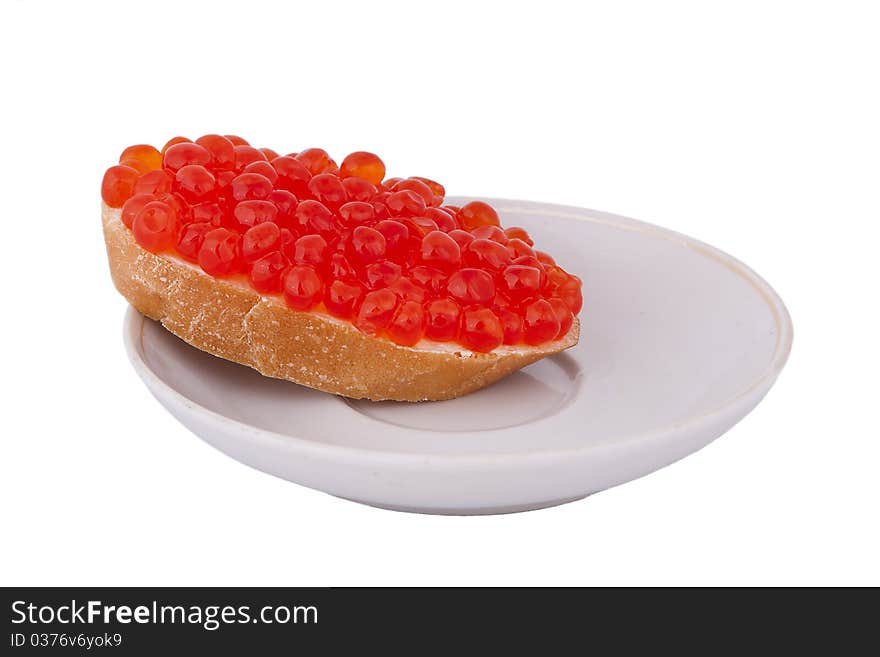 Bread with red caviar on plate on white background