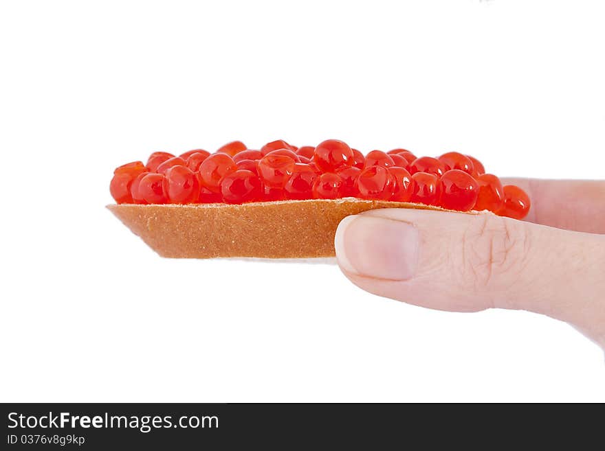 Bread and red caviar in the hend on white background