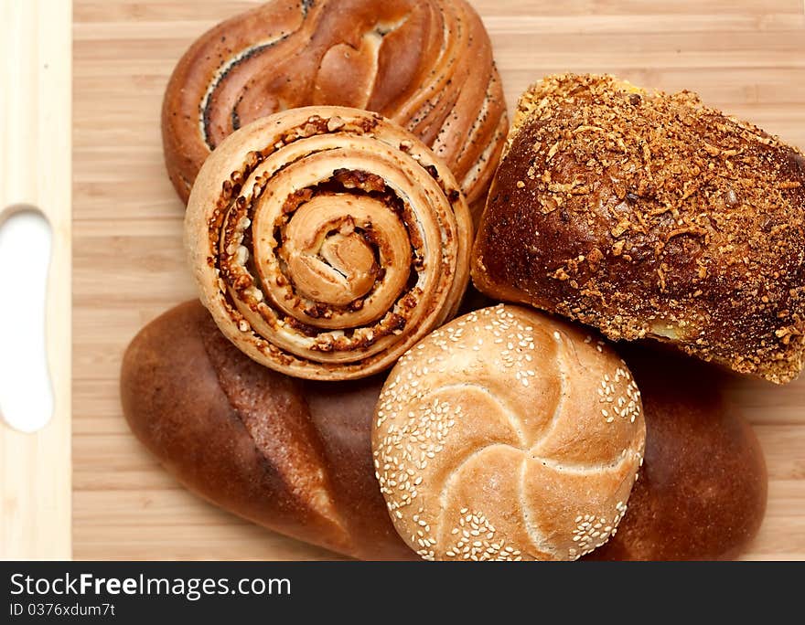 Assortment of baked bread on wood table