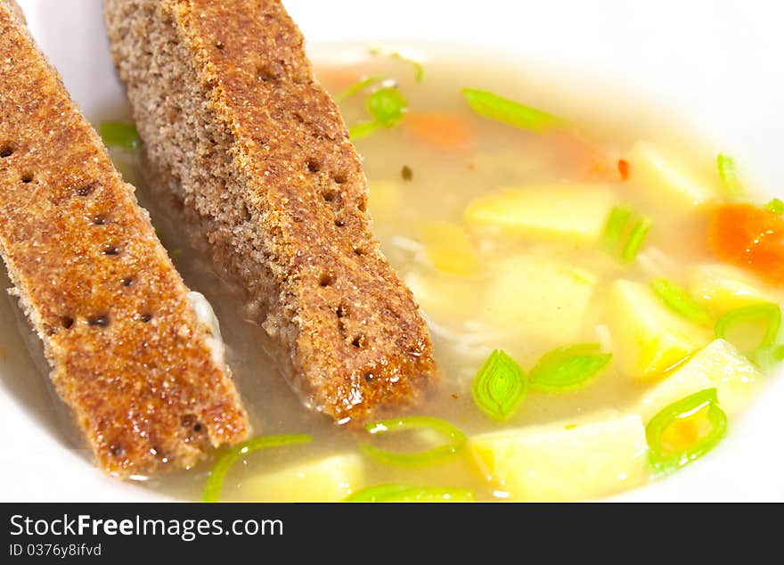 Vegetable soup with patatoes and carrots in white bowl. Vegetable soup with patatoes and carrots in white bowl.