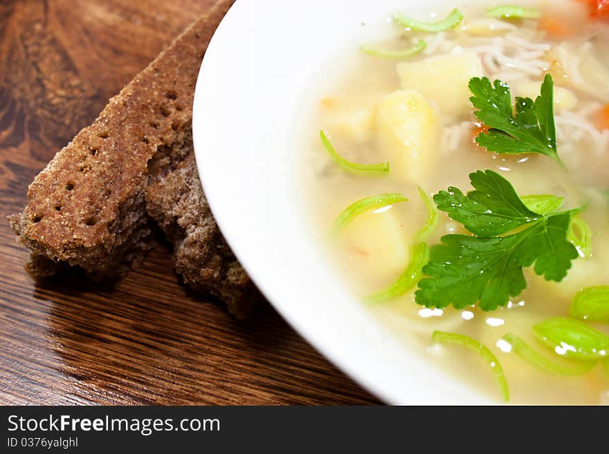 Vegetable soup with patatoes and carrots in white bowl. Vegetable soup with patatoes and carrots in white bowl.