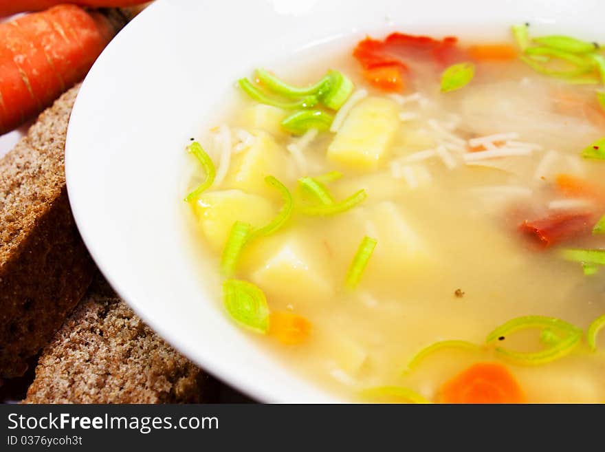 Vegetable soup with patatoes and carrots in white bowl. Vegetable soup with patatoes and carrots in white bowl.