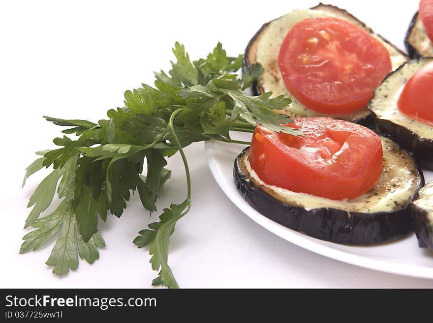 Fried eggplant with tomatoes and garlick sauce on a white background